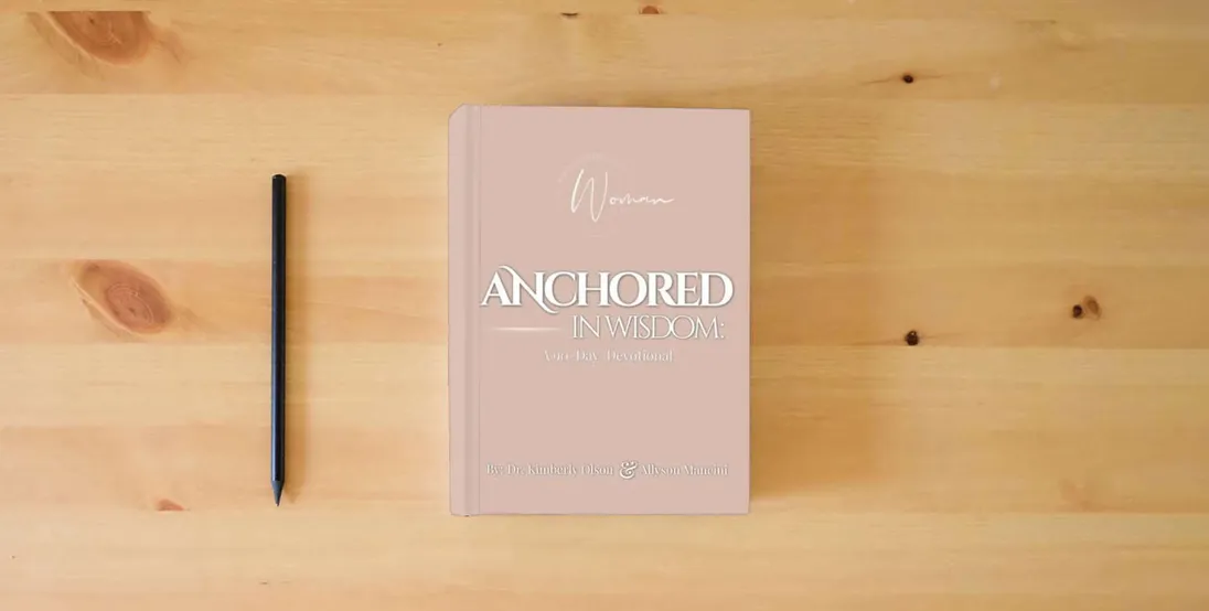 The book Anchored In Wisdom: A 90-Day Devotional} is on the table