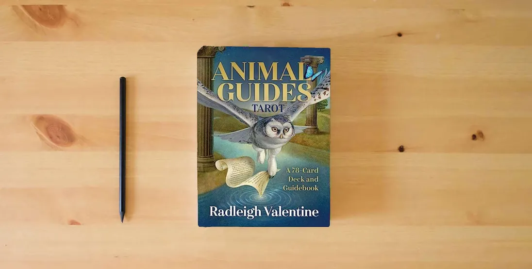 The book Animal Guides Tarot: A 78-Card Deck and Guidebook} is on the table