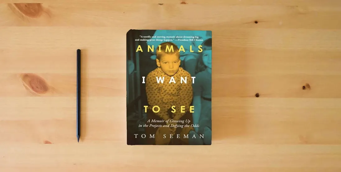 The book Animals I Want To See: A Memoir of Growing Up in the Projects and Defying the Odds} is on the table