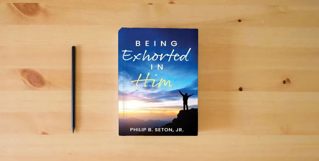 The book Being Exhorted in Him} is on the table