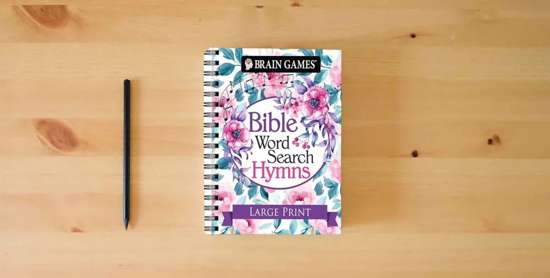 The book Brain Games - Bible Word Search: Hymns - Large Print} is on the table