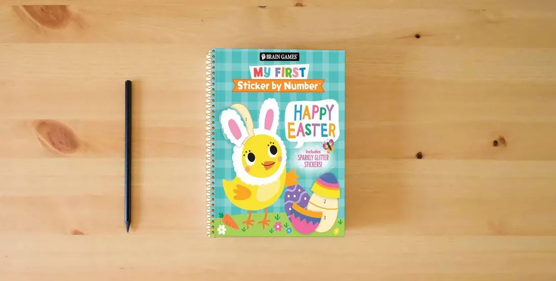 The book Brain Games - My First Sticker by Number: Happy Easter - Includes Sparkly Glitter Stickers!} is on the table