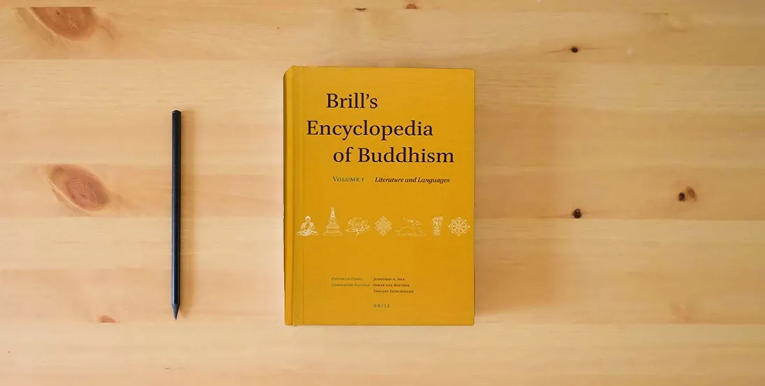 The book Brill's Encyclopedia of Buddhism. Volume One: Literature and Languages (Handbook of Oriental Studies. Section 2 South Asia / Brill's)} is on the table
