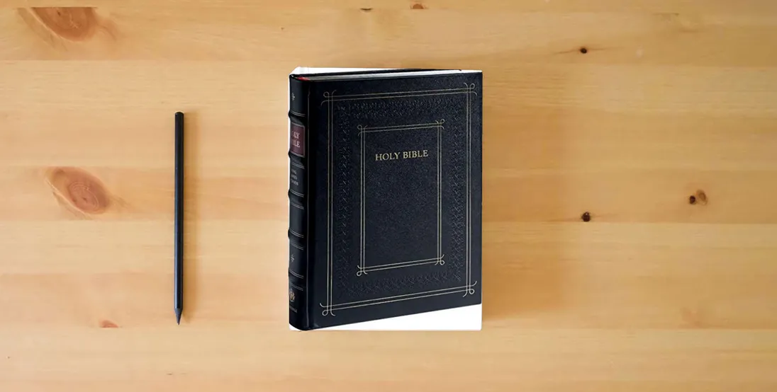 The book Cambridge KJV Family Chronicle Bible, Black Calfskin Leather over Boards, with illustrations by Gustave Doré} is on the table