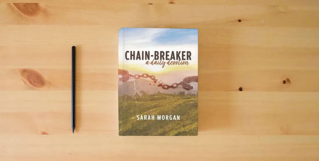The book Chain-breaker: a daily devotion} is on the table