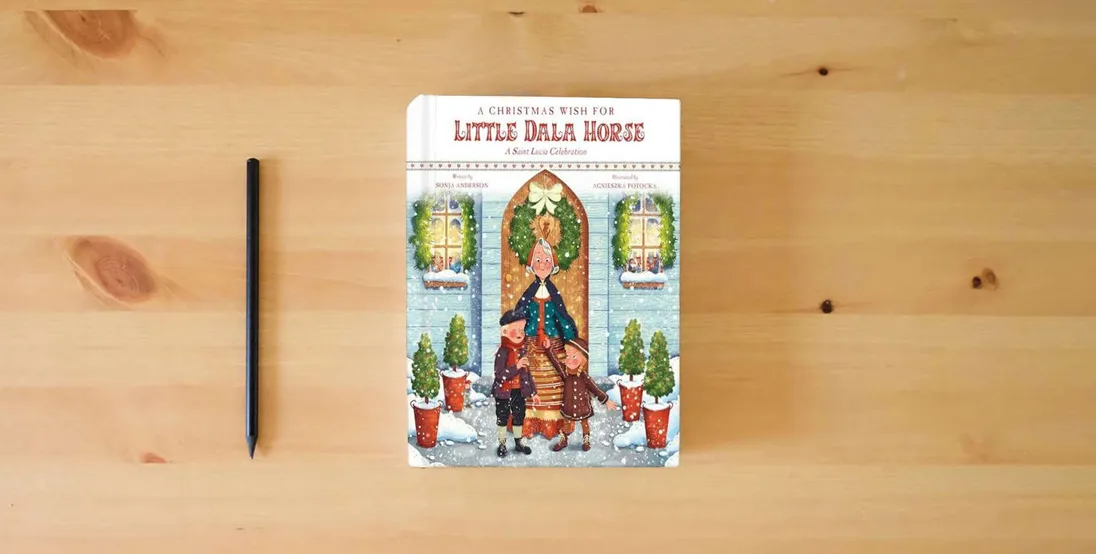 The book A Christmas Wish for Little Dala Horse: A Saint Lucia Celebration} is on the table