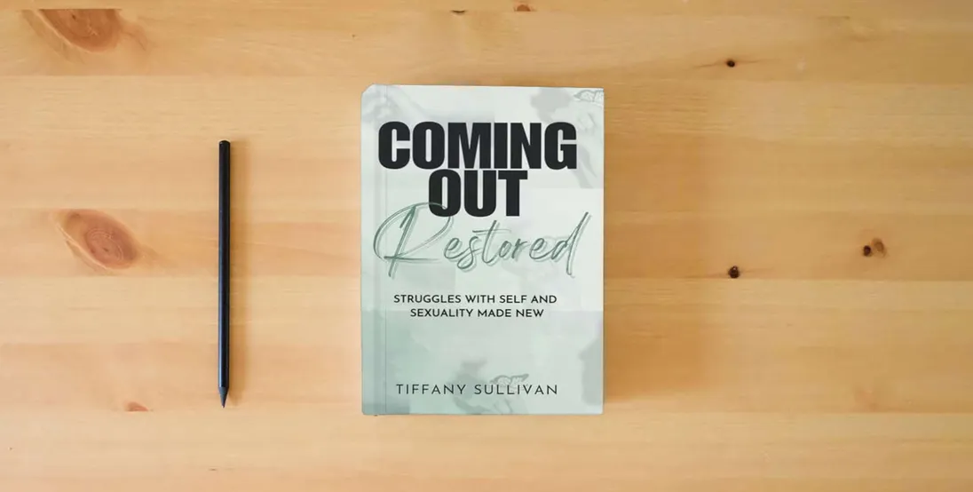The book Coming Out Restored: Struggles with Self and Sexuality Made New} is on the table