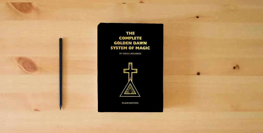 The book Complete Golden Dawn System of Magic Black Edition} is on the table