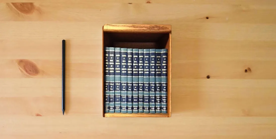 The book Cyclopedia of Biblical, Theological, and Ecclesiastical Literature : 12 Volumes} is on the table