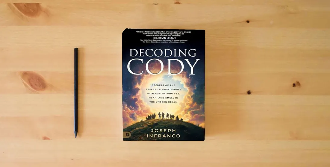 The book Decoding Cody: Secrets of the Spectrum from People with Autism Who See, Hear, and Smell in the Unseen Realm} is on the table