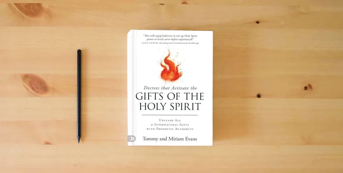 The book Decrees That Activate the Gifts of the Holy Spirit} is on the table