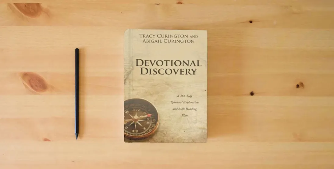 The book Devotional Discovery: A 366-Day Spiritual Exploration and Bible Reading Plan} is on the table