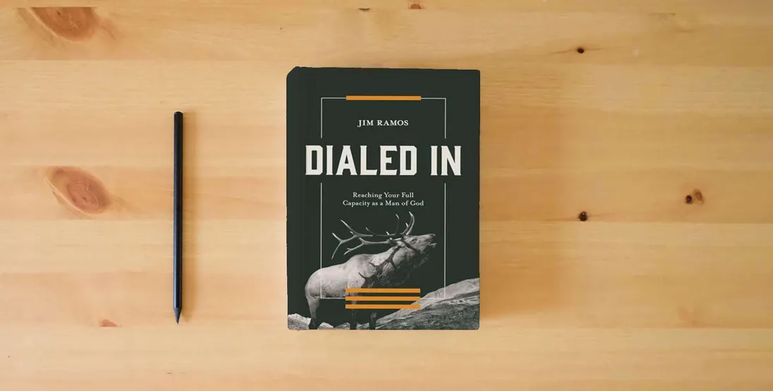 The book Dialed In: Reaching Your Full Capacity as a Man of God} is on the table