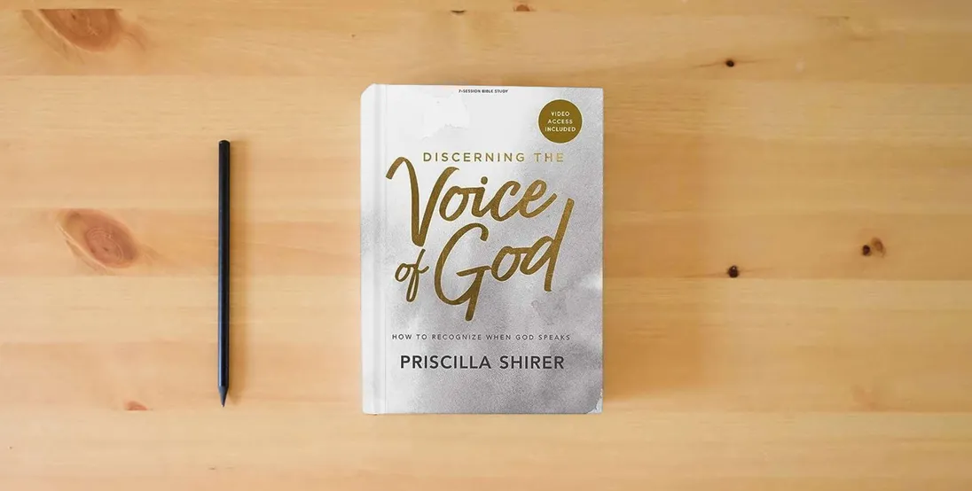 The book Discerning the Voice of God - Bible Study Book with Video Access} is on the table