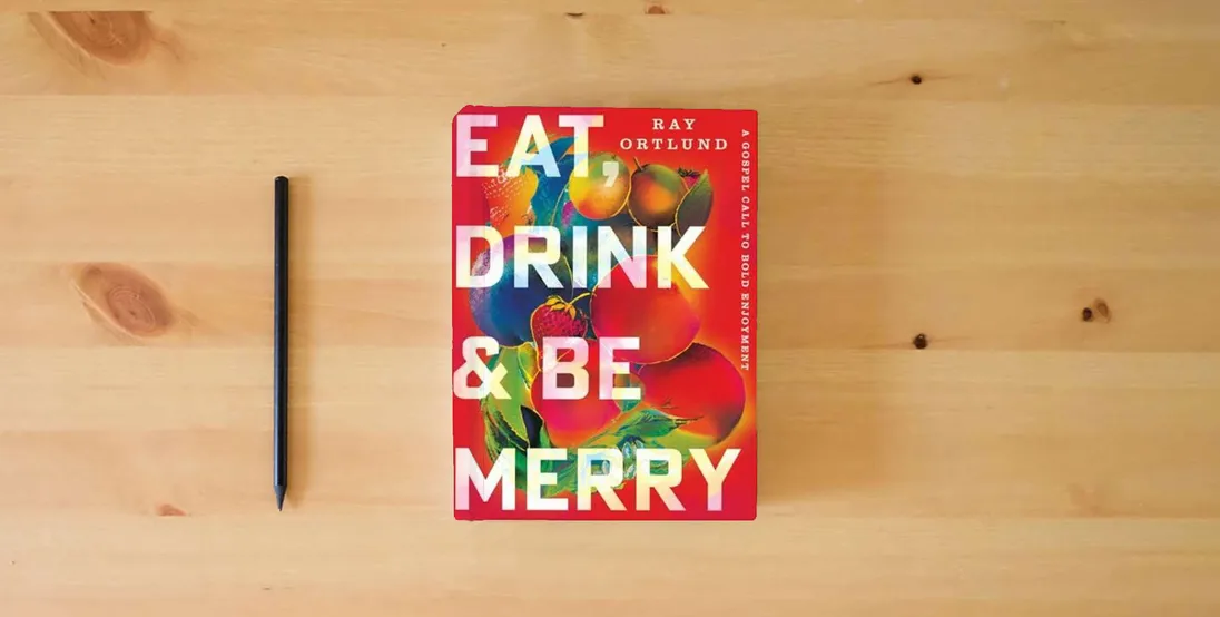 The book Eat, Drink, and Be Merry: A Gospel Call to Bold Enjoyment} is on the table