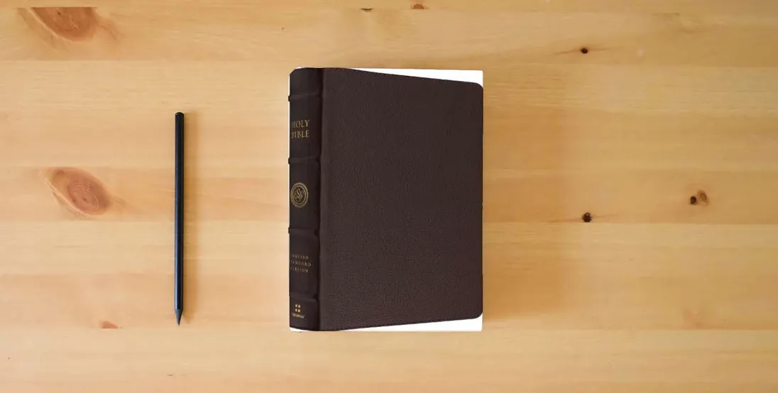 The book ESV Heirloom Bible, Heritage Edition (Calfskin, Mahogany)} is on the table