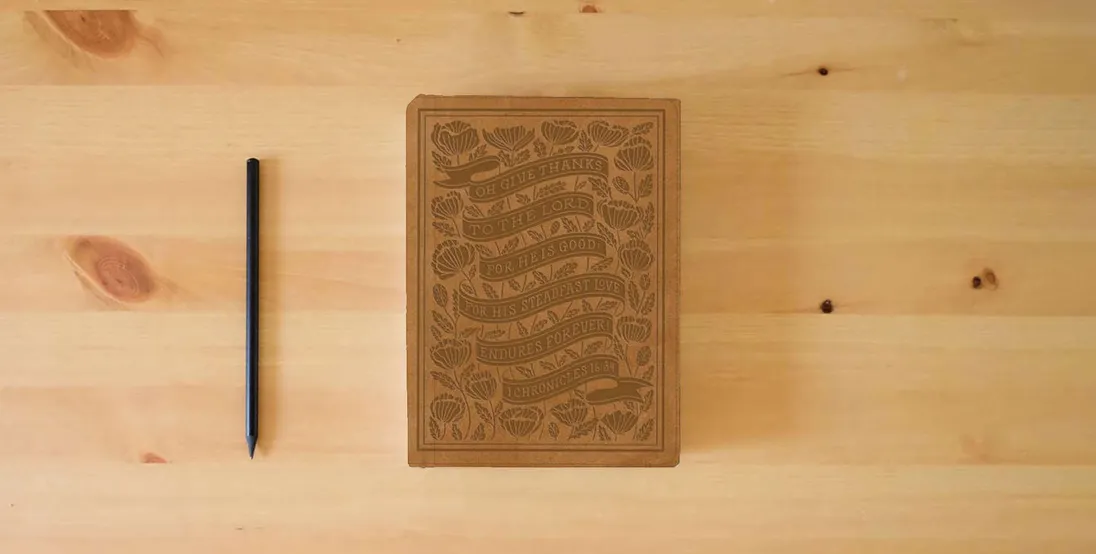 The book ESV Women's Study Bible (TruTone, Nubuck Caramel, 1 Chronicles 16:34 Design): Holy Bible, English Standard Version} is on the table