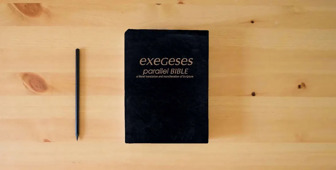 The book Exegeses Parallel Bible} is on the table