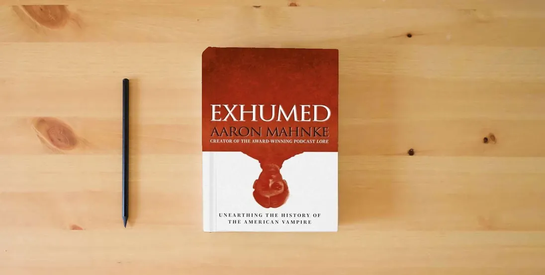 The book Exhumed: Unearthing the History of the American Vampire} is on the table