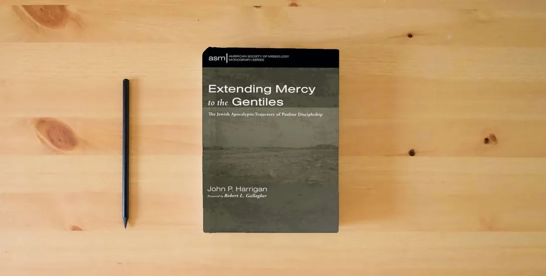 The book Extending Mercy to the Gentiles: The Jewish Apocalyptic Trajectory of Pauline Discipleship (American Society of Missiology Monograph Series)} is on the table