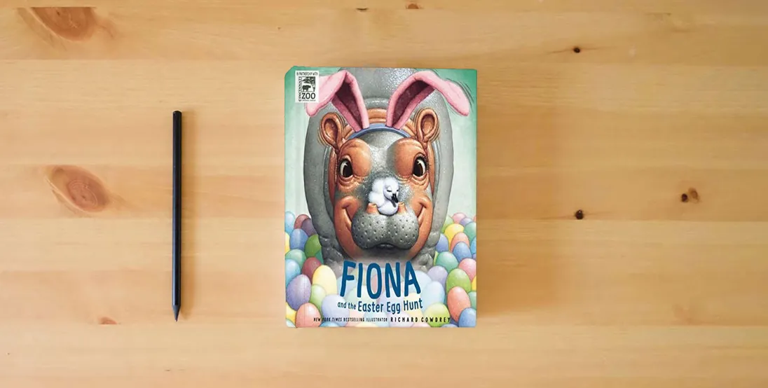 The book Fiona and the Easter Egg Hunt (A Fiona the Hippo Book)} is on the table