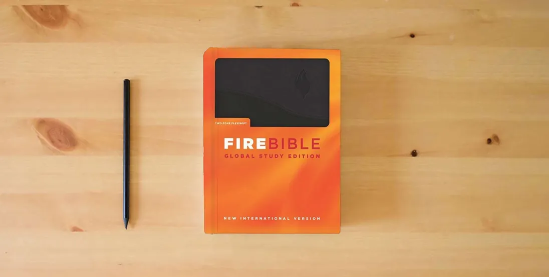 The book Fire Bible: New International Version, Black on Black Flexisoft, Global Study Edition} is on the table