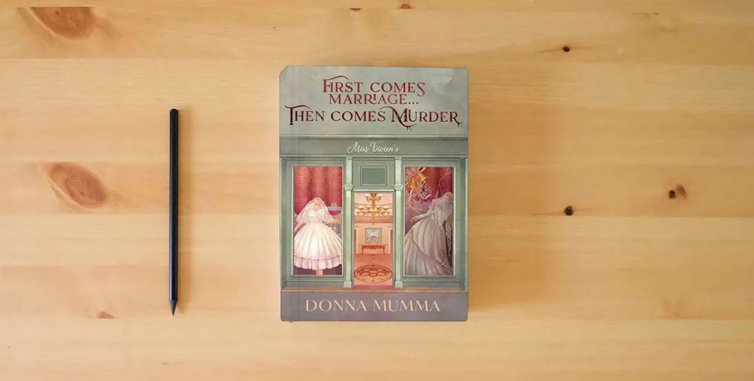 The book First Comes Marriage...Then Comes Murder: A Women of Wynton's Mystery} is on the table