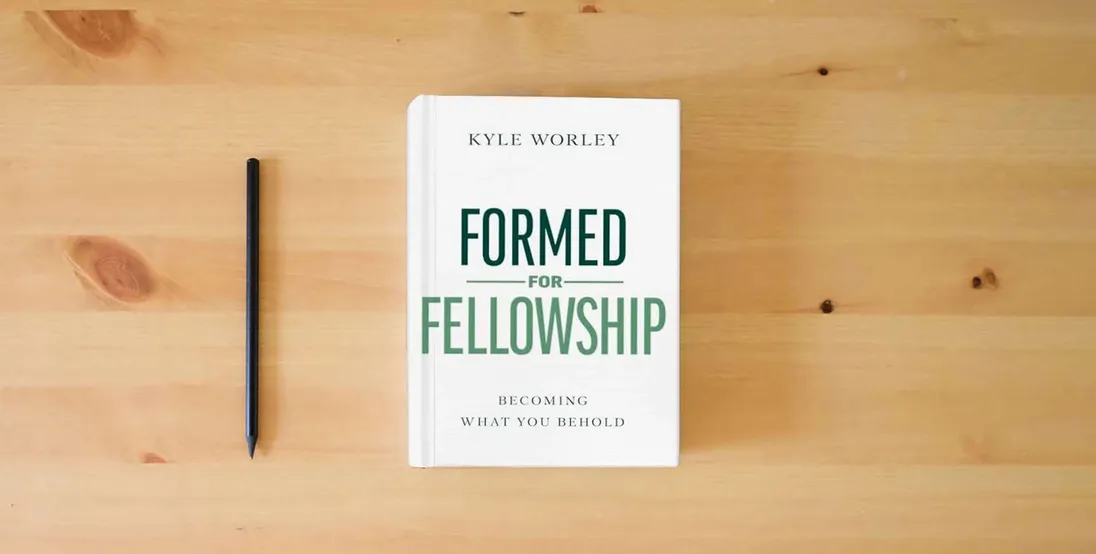 The book Formed for Fellowship: Becoming What You Behold} is on the table