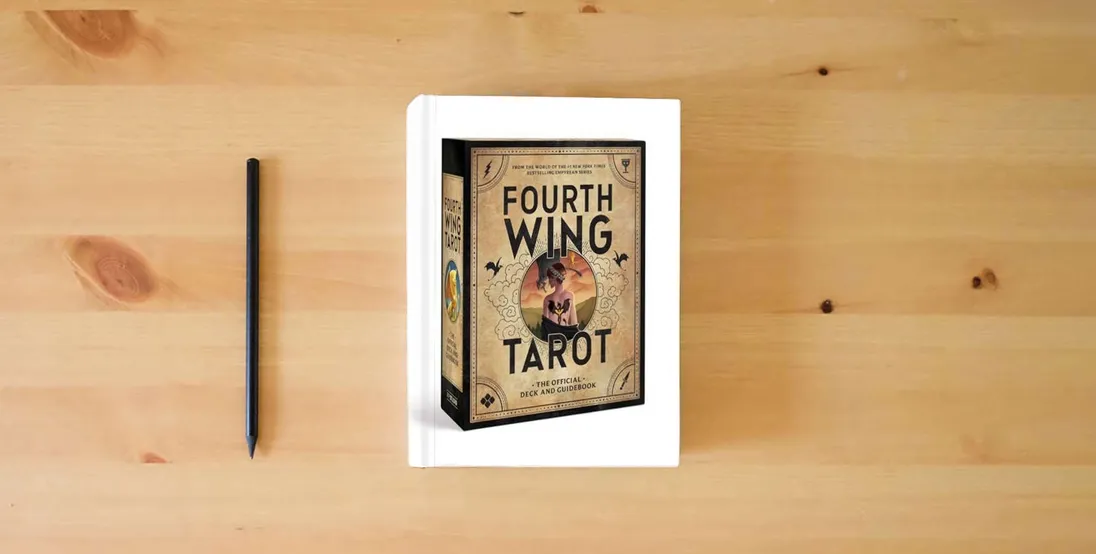 The book Fourth Wing Tarot: The Official Deck and Guidebook from the World of the Empyrean Series} is on the table