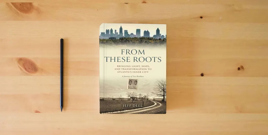 The book From These Roots: Bringing Light, Hope, and Transformation to Atlanta's Inner City―A Journey of Two Brothers} is on the table