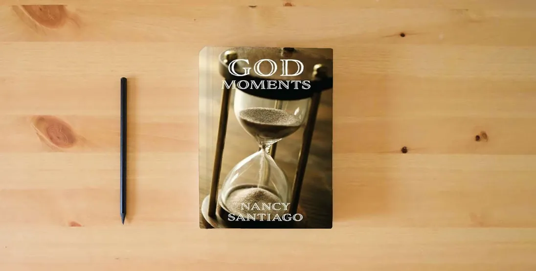 The book God Moments} is on the table