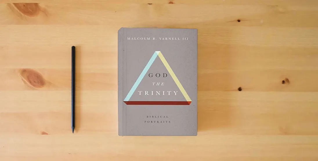 The book God the Trinity: Biblical Portraits} is on the table