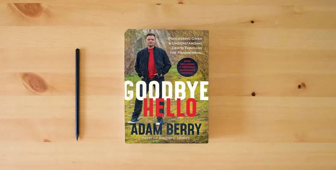 The book Goodbye Hello: Processing Grief and Understanding Death through the Paranormal} is on the table
