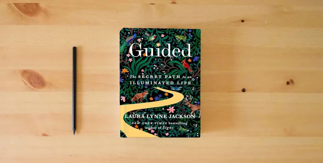 The book Guided: The Secret Path to an Illuminated Life (The Path of Light Series)} is on the table