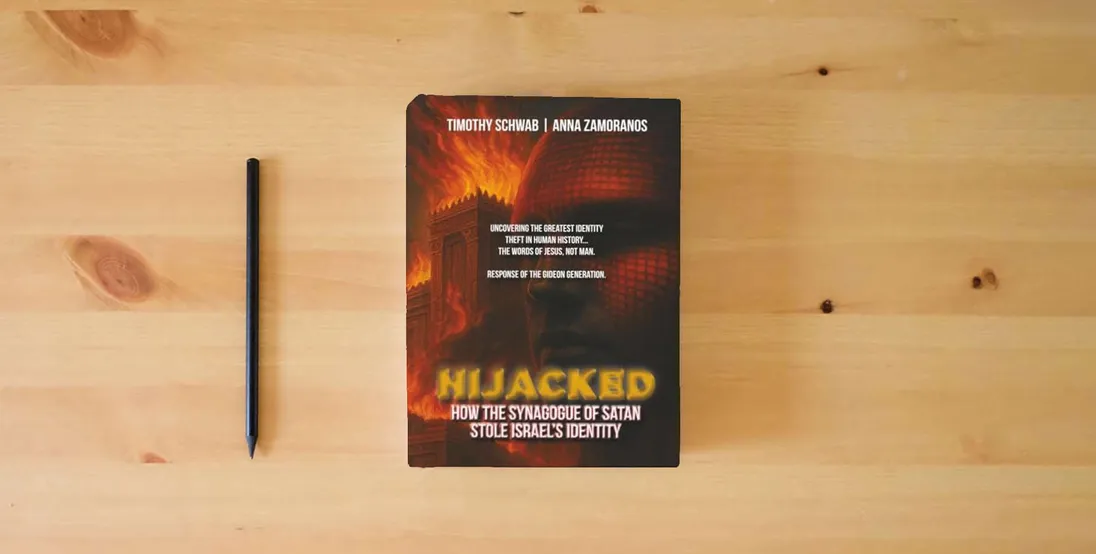 The book HIJACKED: How the Synagogue of Satan Stole Israel’s Identity} is on the table