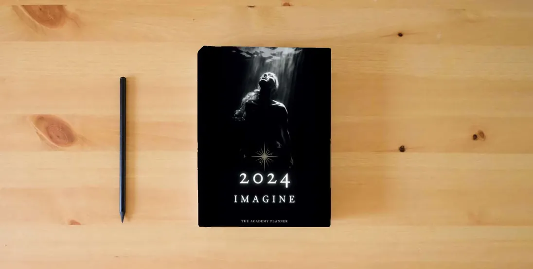 The book Imagine 2024: The Academy Planner} is on the table