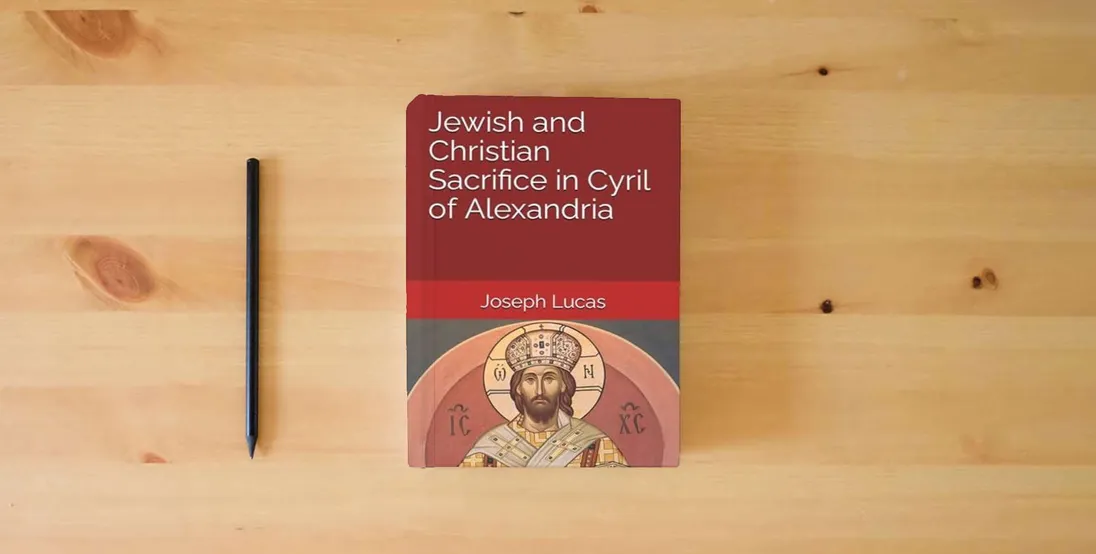 The book Jewish and Christian Sacrifice in Cyril of Alexandria} is on the table