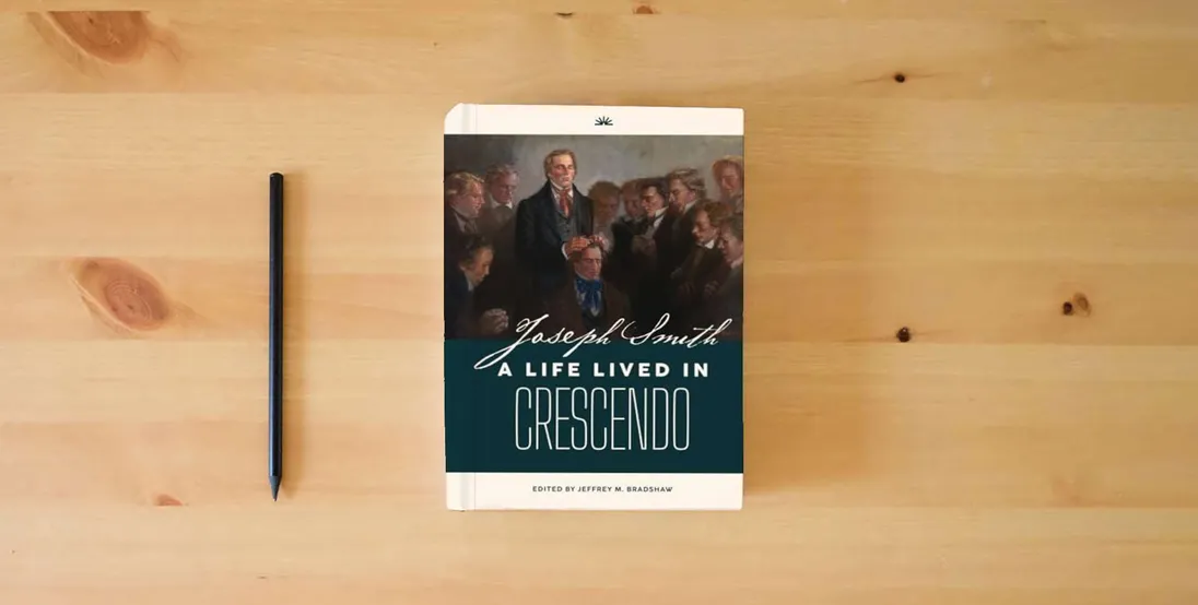 The book Joseph Smith: A Life Lived in Crescendo (Volume 1, Color, Hardback) (Joseph Smith: A Life Lived in Crescendo (Two Volumes))} is on the table