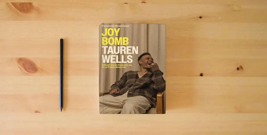 The book Joy Bomb: Unleash Jesus's Explosive Joy for an Extraordinary Life} is on the table