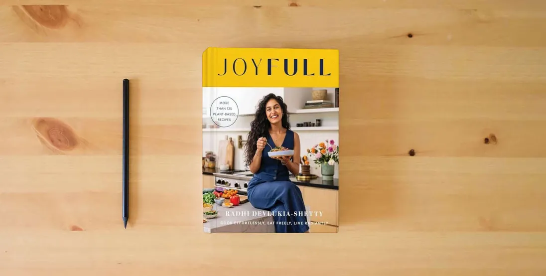 The book JoyFull: Cook Effortlessly, Eat Freely, Live Radiantly (A Cookbook)} is on the table