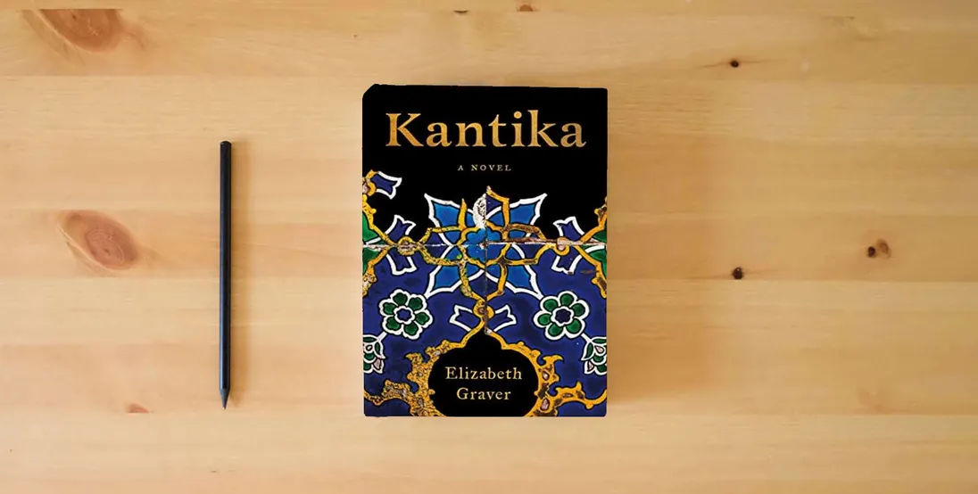 The book Kantika: A Novel} is on the table