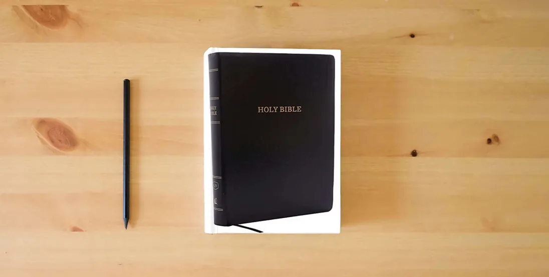 The book KJV Holy Bible, Giant Print Center-Column Reference Bible, Black Leather-look, 53,000 Cross References, Red Letter, Comfort Print: King James Version} is on the table