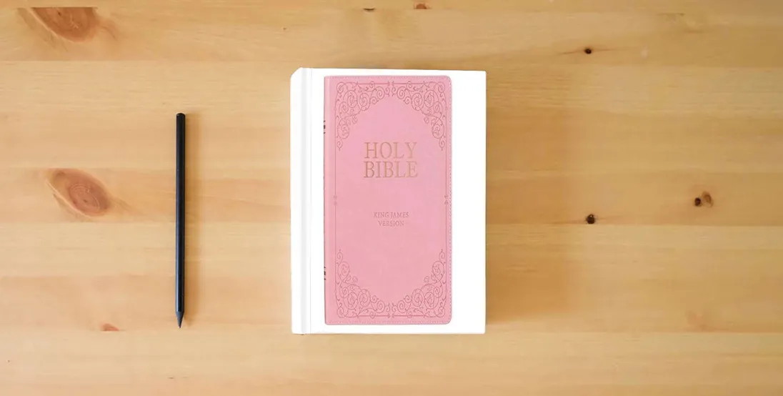 The book KJV Holy Bible, Giant Print Full-Size, Pink Faux Leather w/Ribbon Marker, Red Letter, Thumb Index, King James Version} is on the table