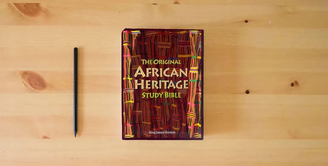 The book KJV The Original African Heritage Study Bible} is on the table