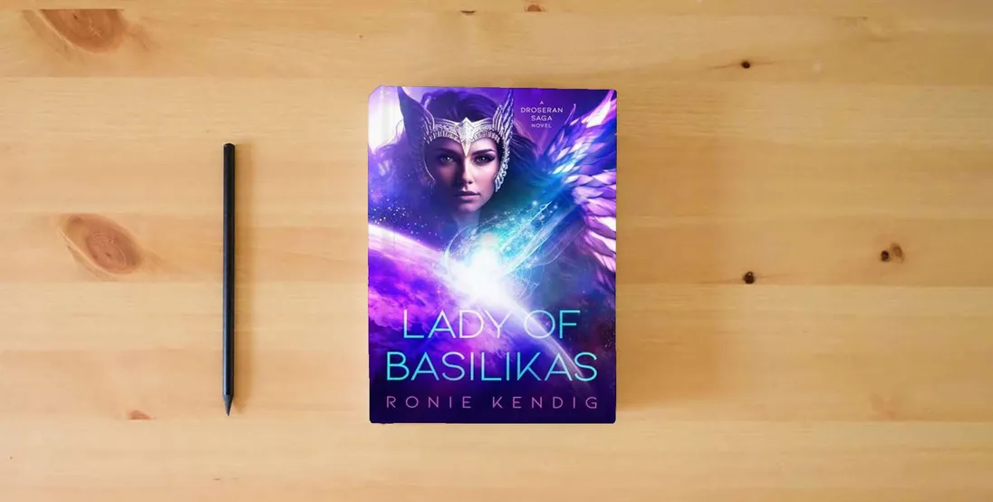 The book Lady of Basilikas: A Droseran Saga Novel (Volume 5) (The Droseran Saga)} is on the table