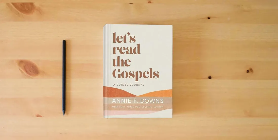 The book Let's Read the Gospels: A Guided Journal} is on the table