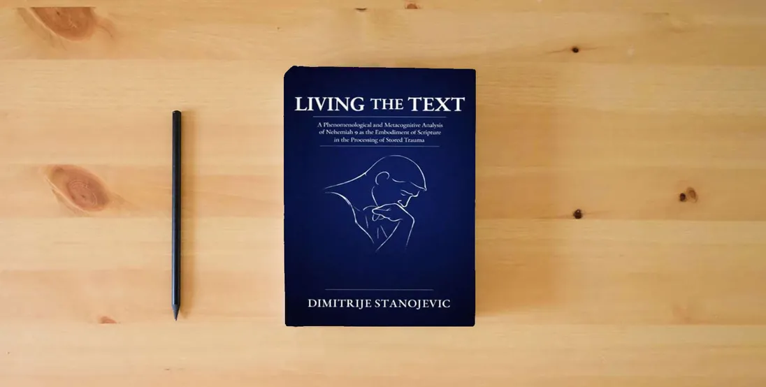 The book Living the Text: A Phenomenological and Metacognitive Analysis of Nehemiah 9 as the Embodiment of Scripture in the Processing of Stored Trauma} is on the table