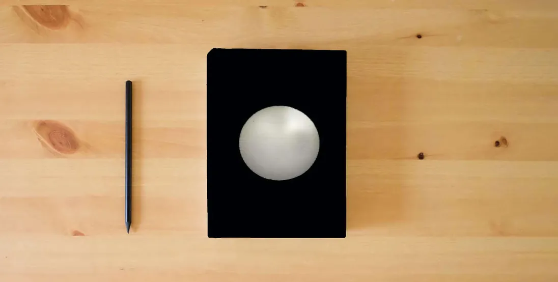 The book Lopsided Moon} is on the table