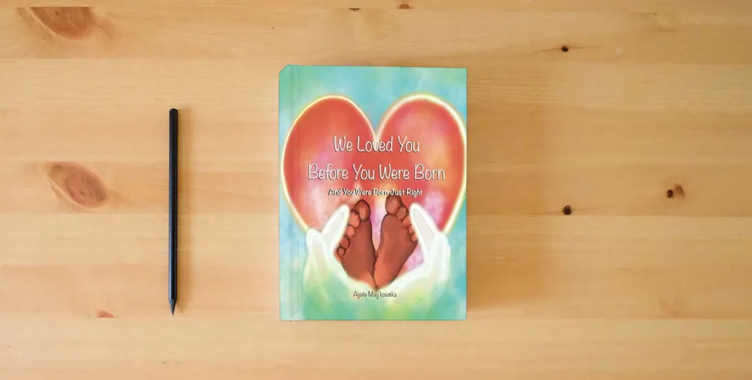 The book We Loved You Before You Were Born: And You Were Born Just Right - Expanded Keepsake Edition} is on the table