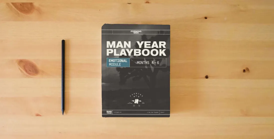 The book Man Year Playbook: Emotional Module} is on the table